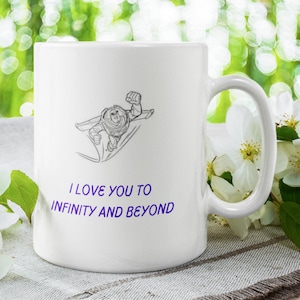 May include: White ceramic coffee mug with a black and white line drawing of Buzz Lightyear from Toy Story. The mug has the text "I love you to infinity and beyond" in purple.