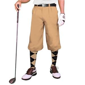May include: A pair of khaki golf shorts with a belt and pleats. The person is wearing black and tan argyle socks and brown and white golf shoes.
