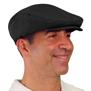 May include: A black, flat-brimmed cap with a slightly curved crown. The cap is made of a soft, textured fabric.