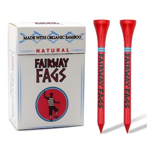 May include: A box of golf tees made from organic bamboo, with the text "FAIRWAY FAGS" and a golfer illustration. Two red golf tees with the same text and a blue stripe are next to the box.