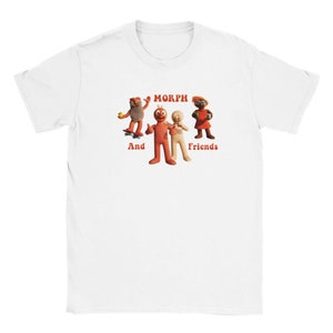 May include: White t-shirt featuring a graphic of Morph and his friends. The text "Morph" is in red and the text "And Friends" is in orange.