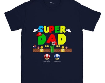 May include: Navy blue t-shirt with a Super Dad graphic in the style of the Super Mario Bros. video game. The graphic includes a mushroom, a pipe, and a question mark block. The text "Natalie" and "Hayden" are printed below the graphic.