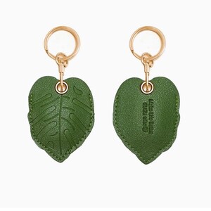 May include: A green leaf-shaped keychain with gold-colored hardware. The front of the leaf has a detailed vein pattern, while the back has the text "Made Life Better" in a circular design. The keychain is a decorative accessory.