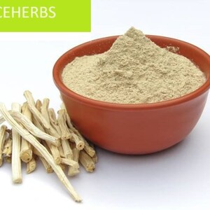 May include: A bowl of light brown powder with a pile of light brown sticks next to it. The bowl is made of terracotta and has a rounded shape. The sticks are thin and have a rough texture. The background is white.
