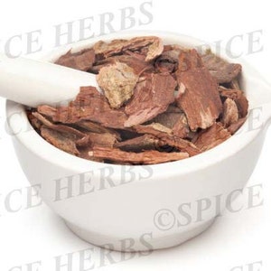 May include: A white ceramic mortar and pestle containing a pile of dried, brown, bark-like pieces.