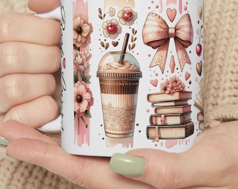 May include: White ceramic mug with a pink, brown, and white design. The design features a stack of books, a cup of coffee, a bow, and flowers.