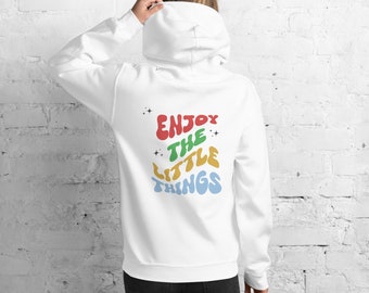 May include: White hooded sweatshirt with the text "Enjoy the little things" in colourful, retro-style lettering.