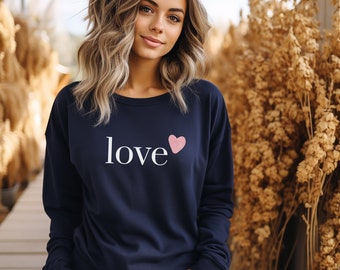 May include: A navy blue sweatshirt with a white "love" graphic and a pink heart.