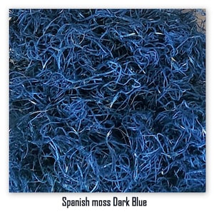 May include: Dark blue Spanish moss. The image shows a close-up of a pile of dark blue Spanish moss, with a tangled, fibrous texture. The text at the bottom of the image reads "Spanish moss Dark Blue."