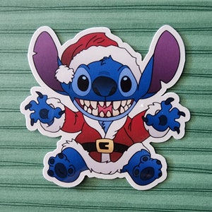 May include: A blue Stitch character wearing a red and white Santa Claus suit with a white fur trim. The character has a big grin and is holding out its arms.
