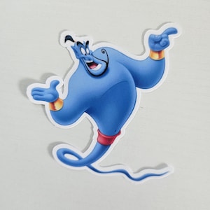 May include: A blue Genie sticker with a white border. The Genie is smiling and pointing with one hand, and has gold wristbands and a red belt. The sticker is a cartoon character from the movie Aladdin.