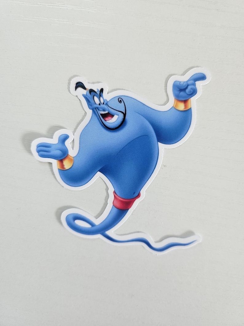 May include: A blue Genie sticker with a white border. The Genie is smiling and pointing with one hand, and has gold wristbands and a red belt. The sticker is a cartoon character from the movie Aladdin.