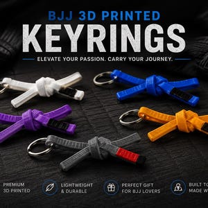 May include: Five 3D printed keyrings shaped like Brazilian Jiu-Jitsu belts in white, blue, purple, orange, and grey with a black or red tip. Each keyring features a metal ring and is displayed with the text BJJ 3D PRINTED KEYRINGS ELEVATE YOUR PASSION. CARRY YOUR JOURNEY.
