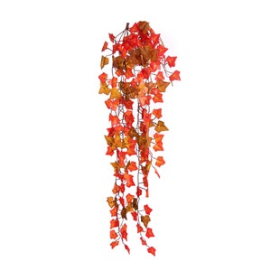 May include: A long strand of artificial ivy with red and orange leaves. The leaves are made of a soft, pliable material and are arranged in a cascading pattern.
