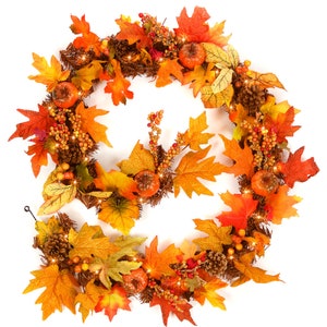 May include: A circular autumn wreath with a variety of decorative elements. It includes orange, yellow, and red leaves, small pumpkins, pine cones, and berries. The wreath is illuminated with small lights, creating a warm, inviting atmosphere. Ideal for seasonal decoration.