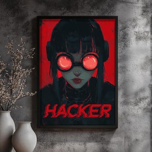 May include: A digital art print featuring a woman with black hair wearing red-lensed goggles. The background is red and the text "HACKER" is in red letters.