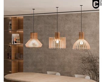 May include: Three wooden pendant lights hanging from a black track in a modern dining room. The lights have a natural wood finish and are made of thin slats of wood. The lights are hanging over a wooden table with chairs.
