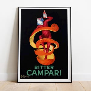 May include: Framed vintage Campari Bitter advertisement. The artwork features a figure in a red polka-dot suit holding a Campari bottle, surrounded by an orange peel on a black background. The words "BITTER CAMPARI" are in green.