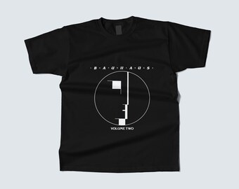 May include: Black t-shirt featuring a white graphic design with the word "BAUHAUS" above a circular geometric design and the words "VOLUME TWO" below. The shirt is a classic crew neck style.