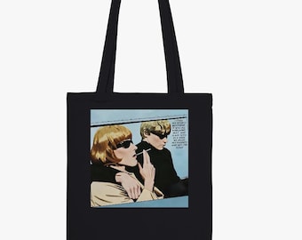 May include: A black tote bag featuring a graphic print of two individuals with blonde hair and sunglasses. One person holds a cigarette, and the other has an arm around them. The text reads: I STOLE MY SISTER'S BOYFRIEND. IT WAS ALL WHIRLWIND, HOT, AND FAST. WITHIN A WEEK WE KILLED MY PARENTS AND HIT THE ROAD.