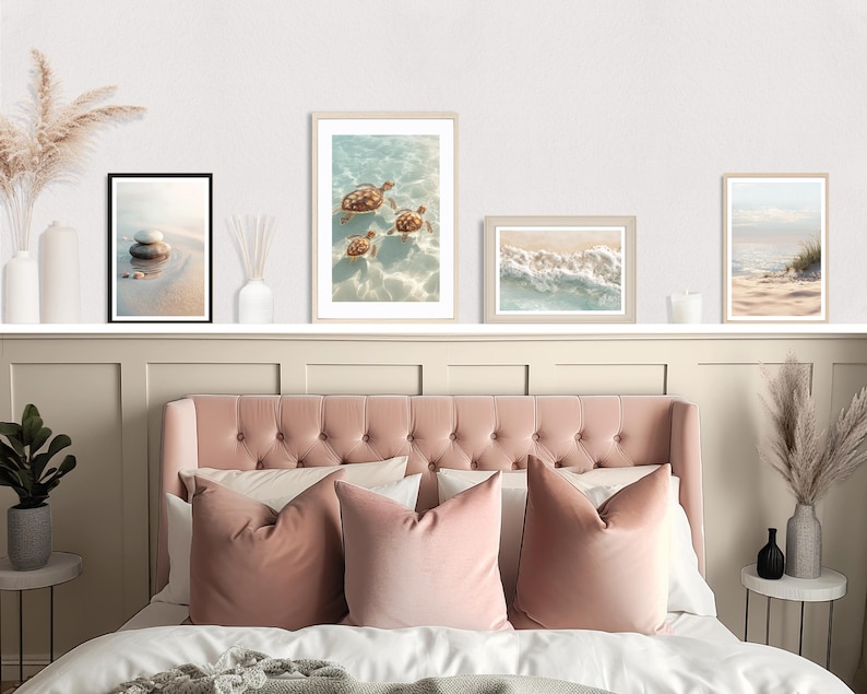 May include: A bedroom scene featuring a pink tufted headboard, matching pillows, and framed beach-themed art. The art includes images of sea turtles, waves, and a beach scene. Decorative vases and a small plant add to the room's aesthetic.