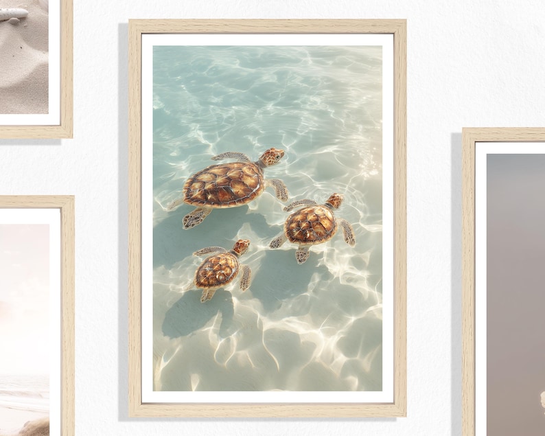 May include: A framed print featuring three sea turtles swimming in clear, turquoise water. The turtles have brown and tan shells, and the water reflects sunlight. The artwork is encased in a light-colored wooden frame, creating a serene coastal scene.