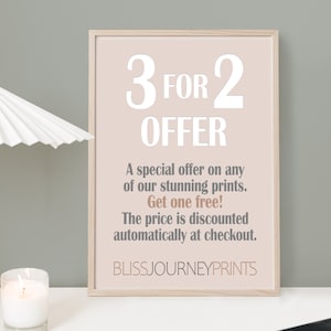 May include: A framed print with the text "3 FOR 2 OFFER" in white, set against a light pink background. The text below details a special offer on prints, with the words "Get one free!" in a contrasting color. The brand name "BLISSJOURNEYPRINTS" is at the bottom.