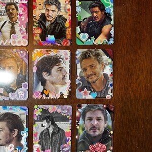 May include: Nine colourful cards featuring the same man on each card. The cards have different borders with various colours, glitter, and cartoon characters.