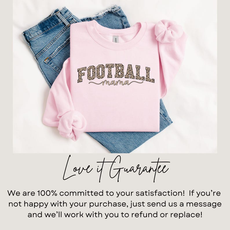 May include: A light pink sweatshirt with the words "FOOTBALL mama" in a leopard print design. The sweatshirt is folded over a pair of blue jeans. The image also includes text that reads "Love it Guarantee".