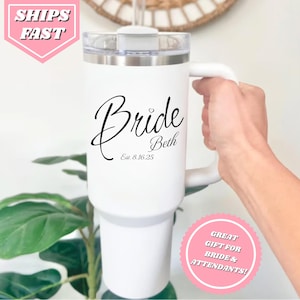May include: White travel mug with a black inscription that reads "Bride Beth Est. 8.16.25".