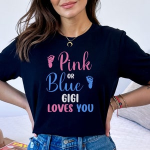 May include: A black t-shirt with the text "Pink or Blue Gigi Loves You" in pink, blue, and gray lettering. The text is surrounded by pink and blue footprints.