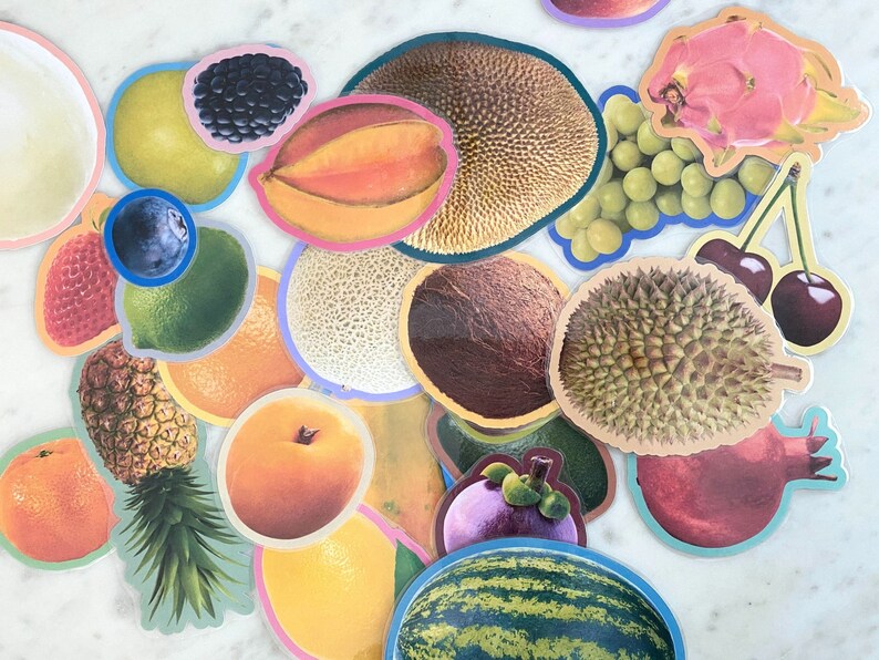 May include: A collection of colorful fruit stickers, including a pineapple, watermelon, orange, and a variety of tropical fruits.