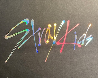 May include: Black t-shirt with a holographic "Stray Kids" logo in rainbow colors.
