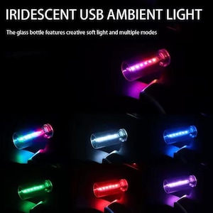 May include: Iridescent USB ambient light in a glass bottle design. The image shows the light in multiple colors, including purple, blue, green, and red. The text on the image reads: "The glass bottle features creative soft light and multiple modes."