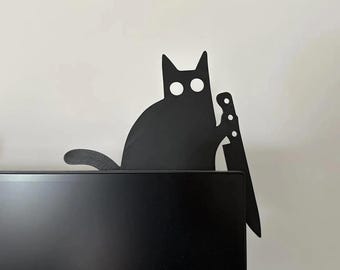 May include: Black silhouette of a cat holding a knife, mounted on a black computer monitor.