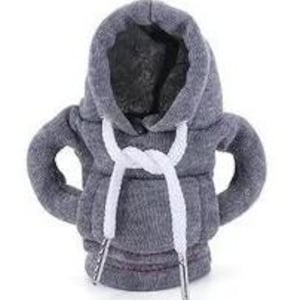 May include: A gray hoodie-shaped bottle cooler with white drawstrings. The cooler has a hood and sleeves, designed to fit around a bottle. The drawstrings are tied at the neck. The cooler is made of a soft, textured fabric.
