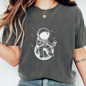 Celestial Gift Tee With A Little Spaceman Sitting On A Tiny Planet Eating Ice Cream. Stargazing And Ice Cream Lover Shirt.