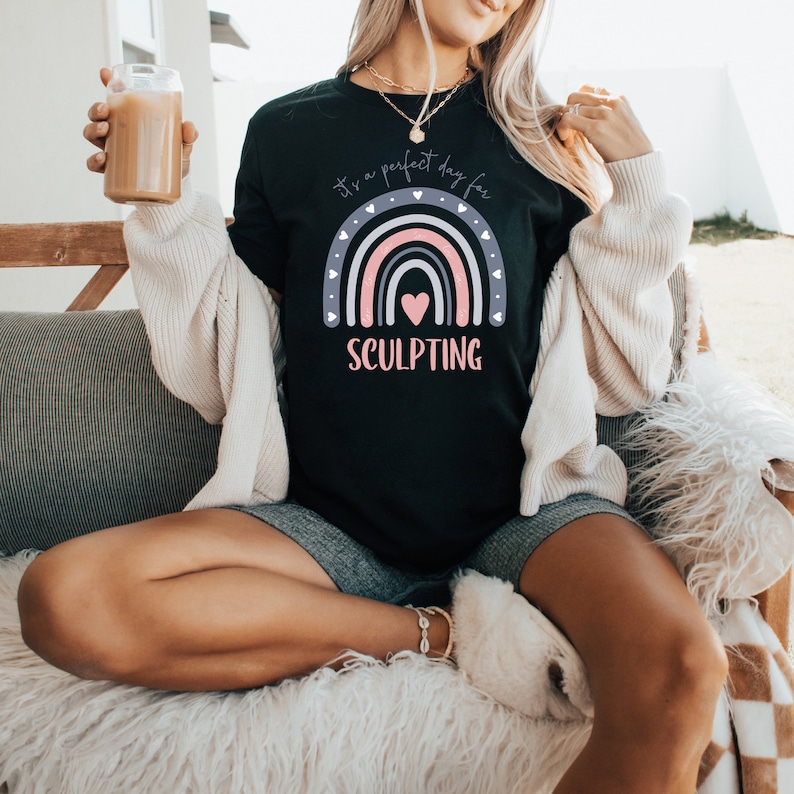 May include: Black t-shirt with a rainbow graphic and the text "It's a perfect day for SCULPTING".