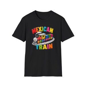 May include: A black short-sleeve t-shirt featuring a graphic of a train made from colorful dominoes on a curved track. The text MEXICAN TRAIN is printed in multi-colored letters above and below the train illustration, which includes red, yellow, blue, and green dominoes.