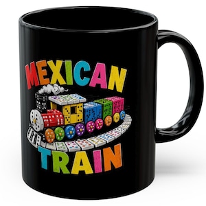 May include: Black ceramic mug featuring a colorful illustration of a train made of dominoes. The train is labeled "Mexican Train" in vibrant, multi-colored text. The design includes a locomotive and several train cars.