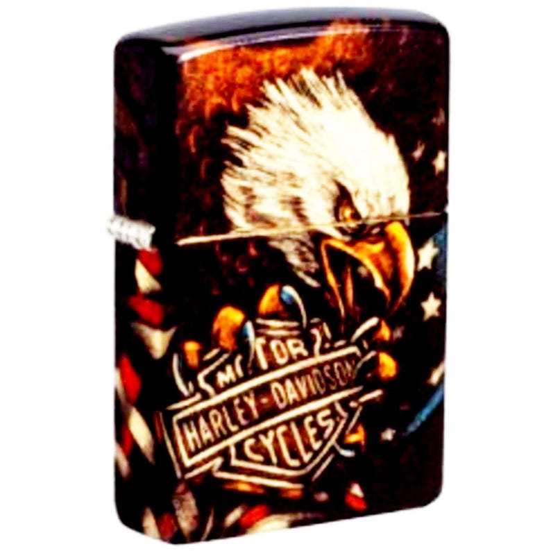 May include: A decorative lighter featuring a detailed illustration of an eagle with a Harley-Davidson Cycles logo. The lighter has a glossy finish with a color palette of brown, red, white, and blue.