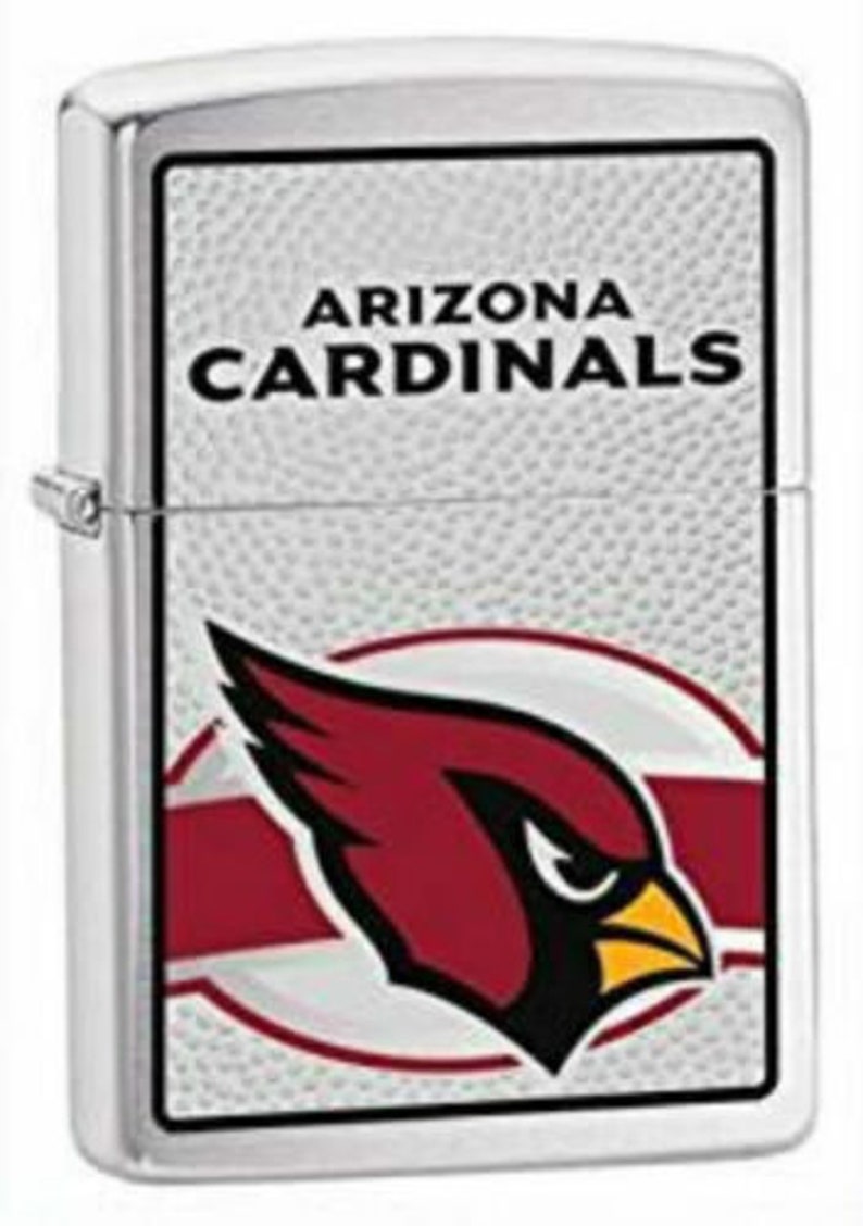 May include: Silver lighter with a white background and a red cardinal logo. The text "Arizona Cardinals" is printed in black above the logo.