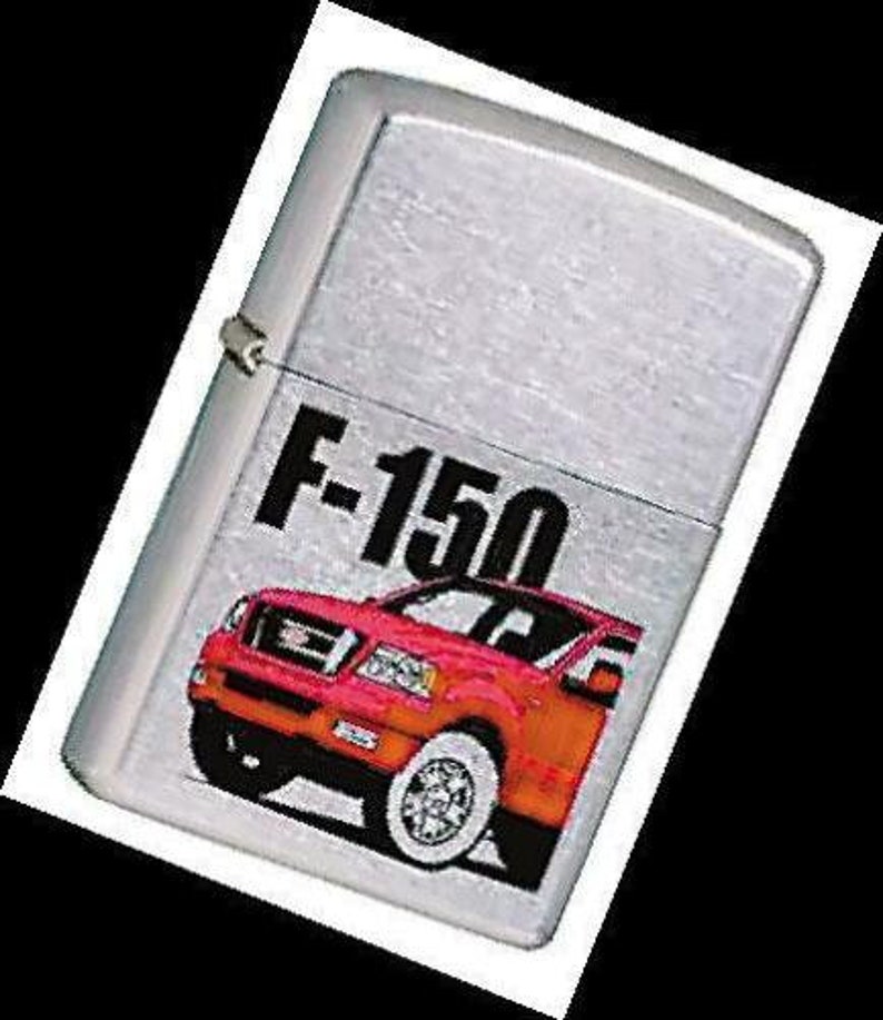 May include: Silver lighter with a red Ford F-150 pickup truck graphic. The truck has a black grill and black wheels.