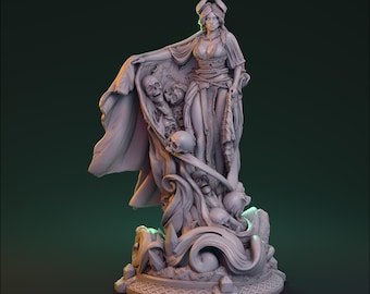 May include: A detailed, gray figurine of a woman with horns, draped in a flowing cloak adorned with skulls. The base features intricate carvings and the text "HARDWITCH GAMES HUNT GROTESQUE LADIES".