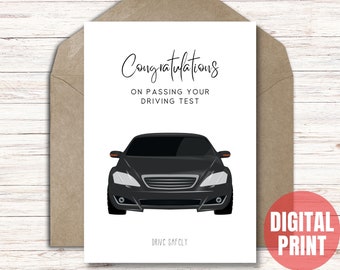 May include: A white card with the words "Congratulations ON PASSING YOUR DRIVING TEST" and a black car illustration. The card is inside a brown envelope. The words "DRIVE SAFELY" are at the bottom.