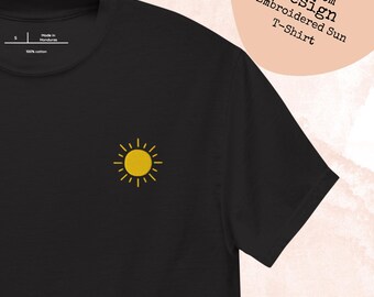 May include: Black t-shirt with a small embroidered yellow sun design on the chest. The shirt has the text "custom Design Embroidered Sun T-Shirt" on the upper right. Made of 100% cotton.