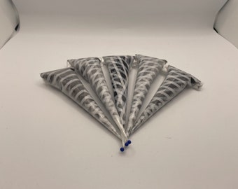 May include: Five black and white striped henna cones with blue tips, arranged in a fan shape on a white surface.