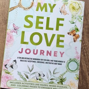 May include: A workbook titled "MY SELF LOVE JOURNEY" with a floral and butterfly design. The cover features the title in large green letters, with text below describing the workbook's purpose. Includes mazes, word puzzles, and coloring pages.