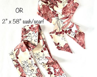 May include: Two floral patterned scarves in shades of cream and burgundy. The shorter scarf is 2 inches by 35 inches. The longer scarf is 2 inches by 58 inches.  Choose: 2" x 35" short scarf OR 2" x 58" sash/scarf