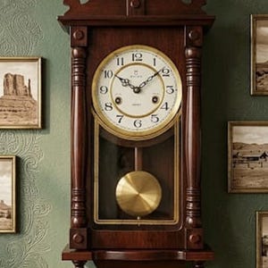 May include: A dark brown wooden wall clock featuring a circular white face with black Arabic numerals and the Seiko brand name. The clock includes a gold-toned pendulum visible through a glass panel, decorative finials, and a carved top crest.